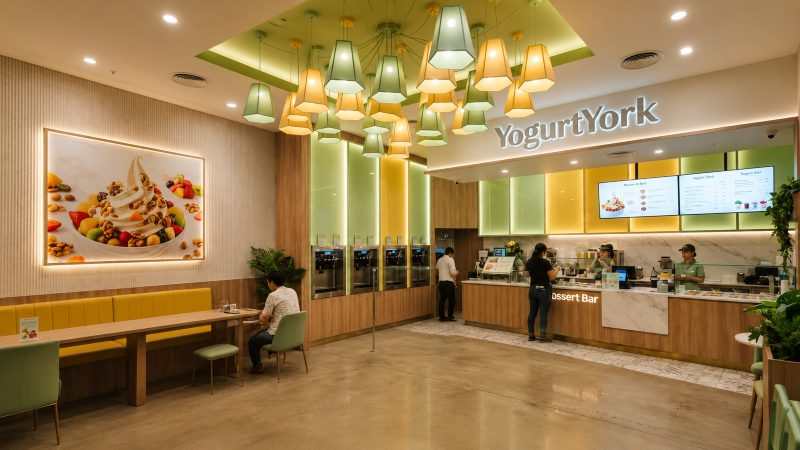 The YogurtYork dessert bar with self-serve frozen yogurt machines and seating inside a modern store